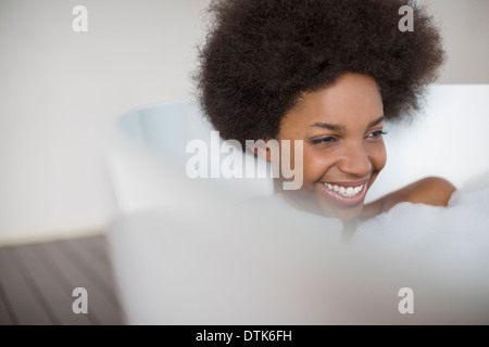 Woman laughing in bath Stock Photo