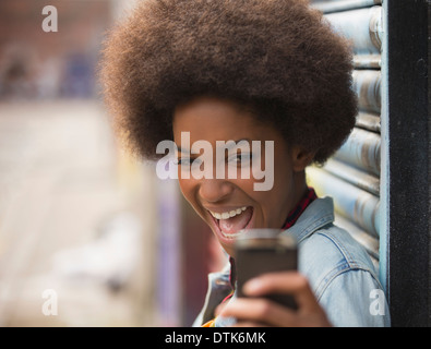 Woman taking self-portrait with cell phone outdoors Stock Photo