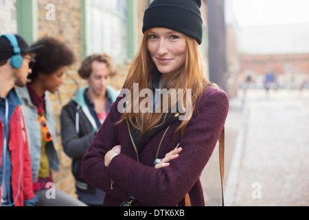 Woman smiling on city street Stock Photo