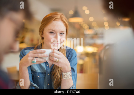 Friends enjoying coffee in cafe Stock Photo