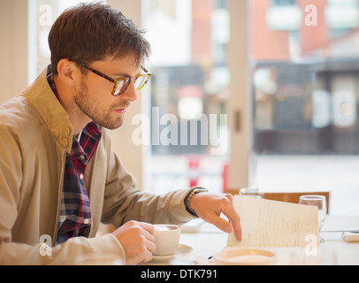 Man drinking coffee in cafe Stock Photo