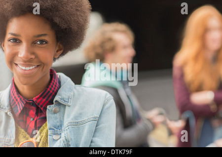 Woman smiling with friends in background Stock Photo