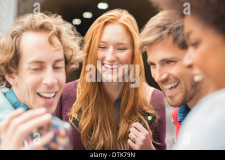 Friends laughing together outdoors Stock Photo