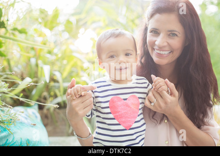 Mother holding daughter outdoors Stock Photo