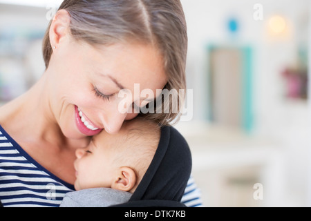 Mother holding sleeping baby boy Stock Photo