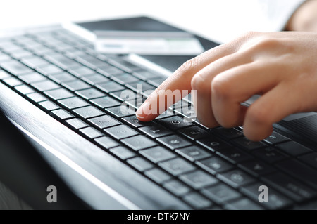 Female hands using laptop and credit card on background  Stock Photo