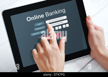 Female hands using online banking on touch screen device Stock Photo