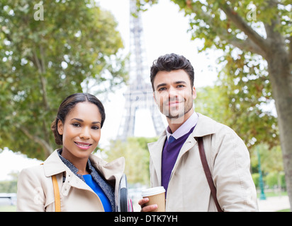 Business people smiling in park near Eiffel Tower, Paris, France Stock Photo