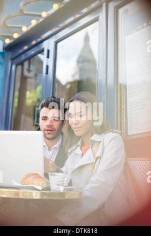 Business people using laptop at sidewalk cafe Stock Photo