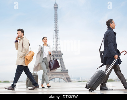 Business people walking near Eiffel Tower, Paris, France Stock Photo