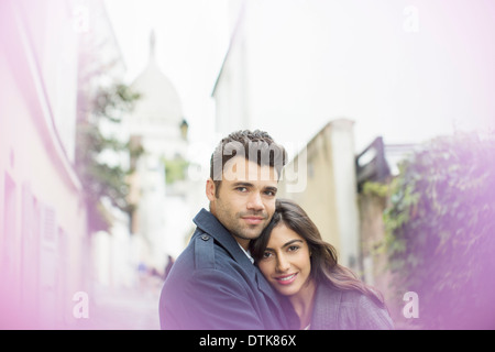 Couple hugging in urban alley Stock Photo