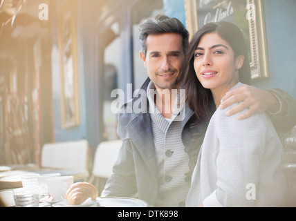 Couple sitting together at sidewalk cafe Stock Photo