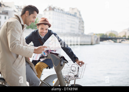 Men looking at map along Seine River, Paris, France Stock Photo