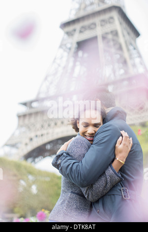 Couple hugging in front of Eiffel Tower, Paris, France Stock Photo