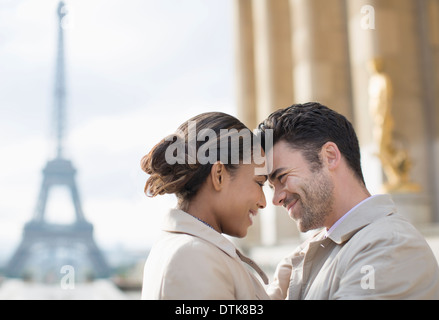 Couple hugging in front of Eiffel Tower, Paris, France Stock Photo