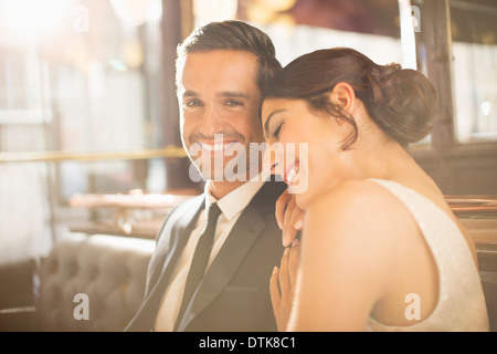 Well-dressed couple hugging in restaurant Stock Photo
