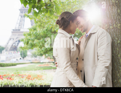 Couple kissing in park near Eiffel Tower, Paris, France Stock Photo