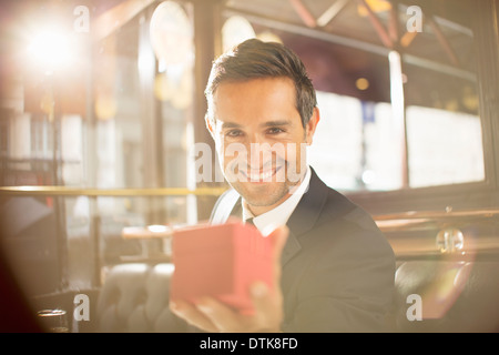 Well-dressed man holding jewelry box in restaurant Stock Photo