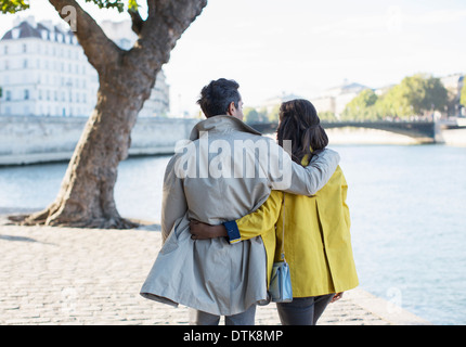 Couple walking along Seine River, Paris, France Stock Photo