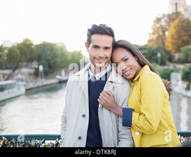 Couple hugging on Pont des Arts bridge over Seine River, Paris, France Stock Photo