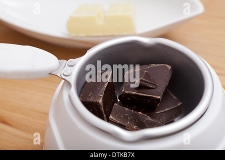 Chocolate Melting Pot filled with brown chocolate Stock Photo