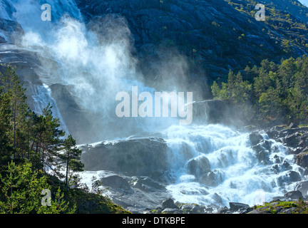 Summer mountain Langfossen waterfall on slope (Etne, Norway). Stock Photo