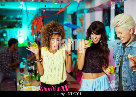 Women taking shots at party Stock Photo
