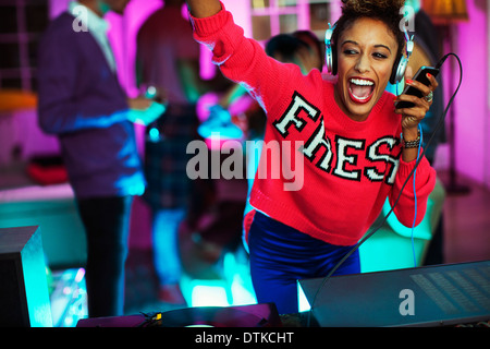 Woman playing music at party Stock Photo
