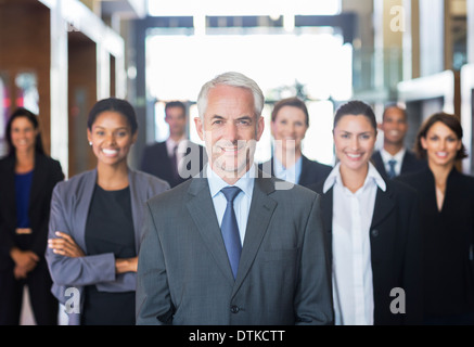Business people smiling in lobby Stock Photo