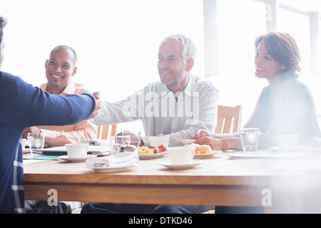 Business people shaking hands in meeting Stock Photo