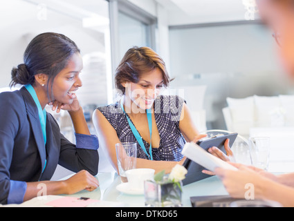 Businesswomen using digital tablet in meeting Stock Photo