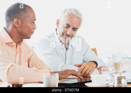 Businessmen talking in cafe Stock Photo