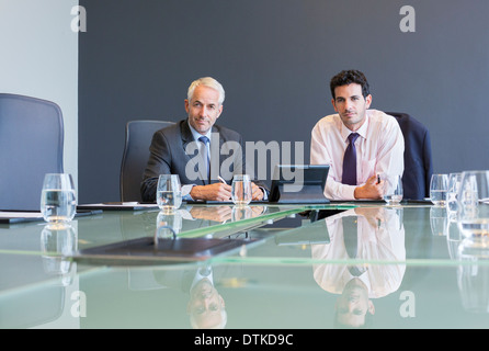 Businessmen using digital tablet in meeting Stock Photo
