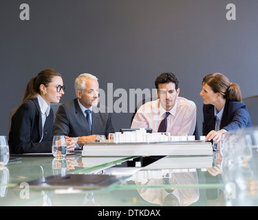 Business people looking at architectural model in office Stock Photo