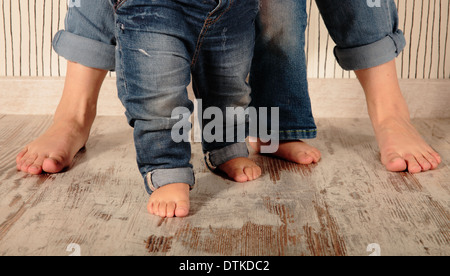 mom and daughters barefoot in jeans Stock Photo