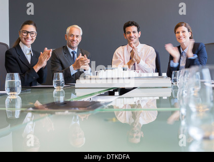 Business people applauding in meeting Stock Photo