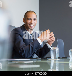 Businessman smiling in meeting Stock Photo