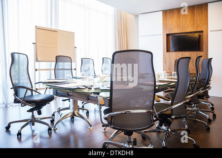 Chairs and table in empty meeting room Stock Photo