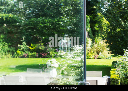 View of landscaped garden through open door Stock Photo