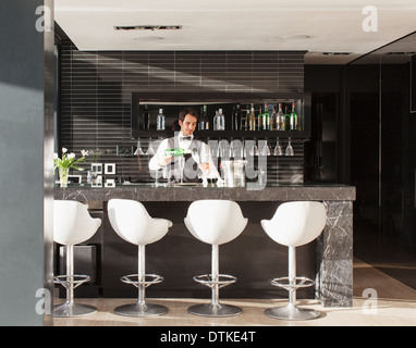 Waiter making drinks in bar Stock Photo