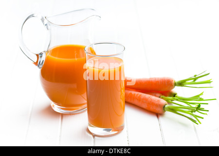 carrot juice in glass and pitcher Stock Photo