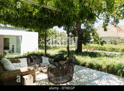 Fire pit and armchairs on luxury patio overlooking vineyard Stock Photo