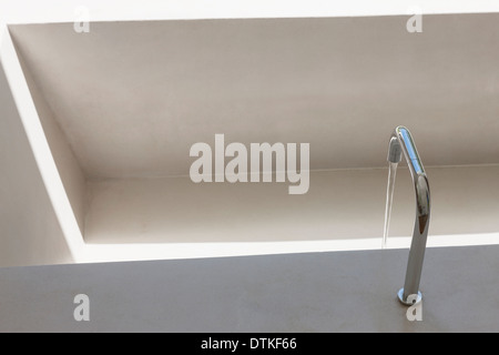 Water from faucet filling bathtub Stock Photo