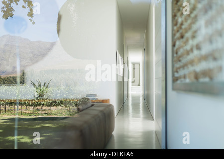 Glass walls of modern house overlooking vineyard Stock Photo