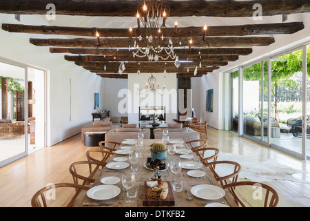 Chandelier over dining table in luxury house Stock Photo