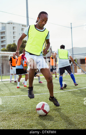 Soccer player training on field Stock Photo