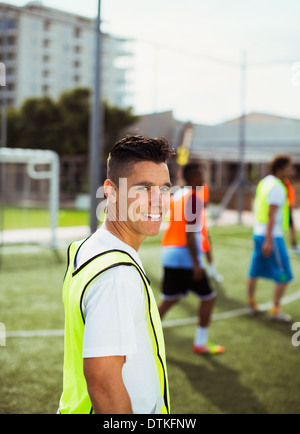 Soccer player smiling on field Stock Photo