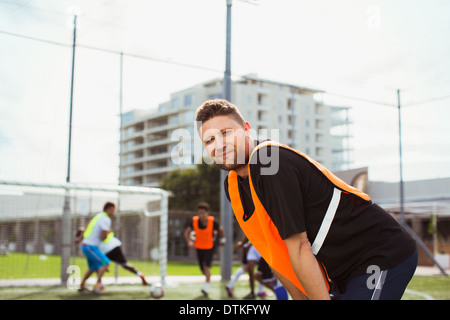 Soccer player smiling on field Stock Photo