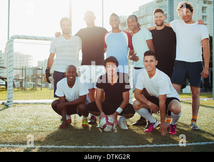 Soccer players smiling on field Stock Photo
