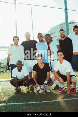 Soccer players smiling on field Stock Photo